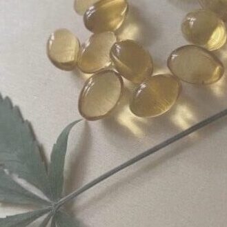 CBD Supplements With hemp Leaf And Grey Background